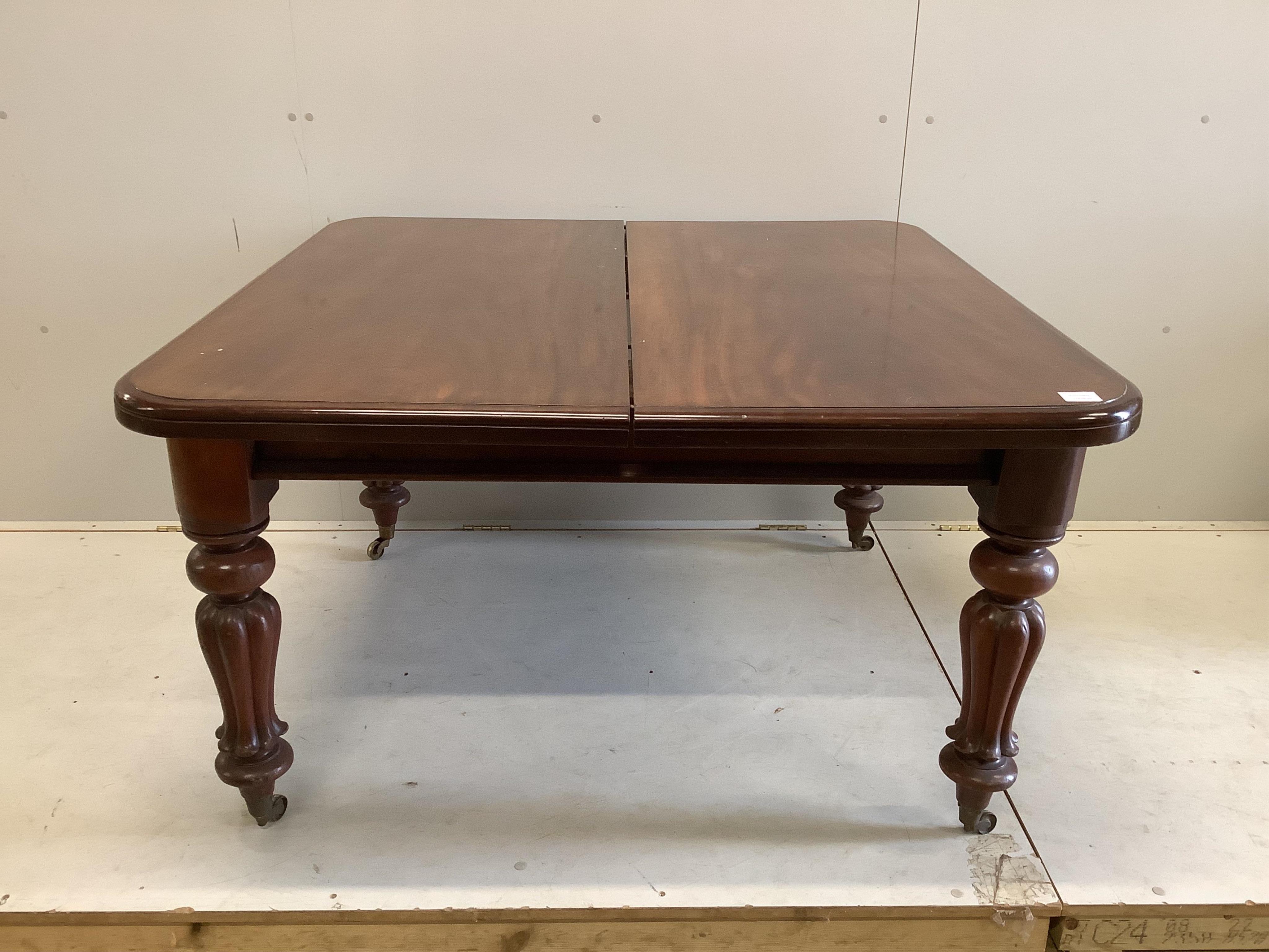 A Victorian mahogany extending dining table, width 238cm extended, two spare leaves, depth 120cm, height 68cm together with a set of six reproduction Regency style dining chairs (two with arms). Condition - fair to good